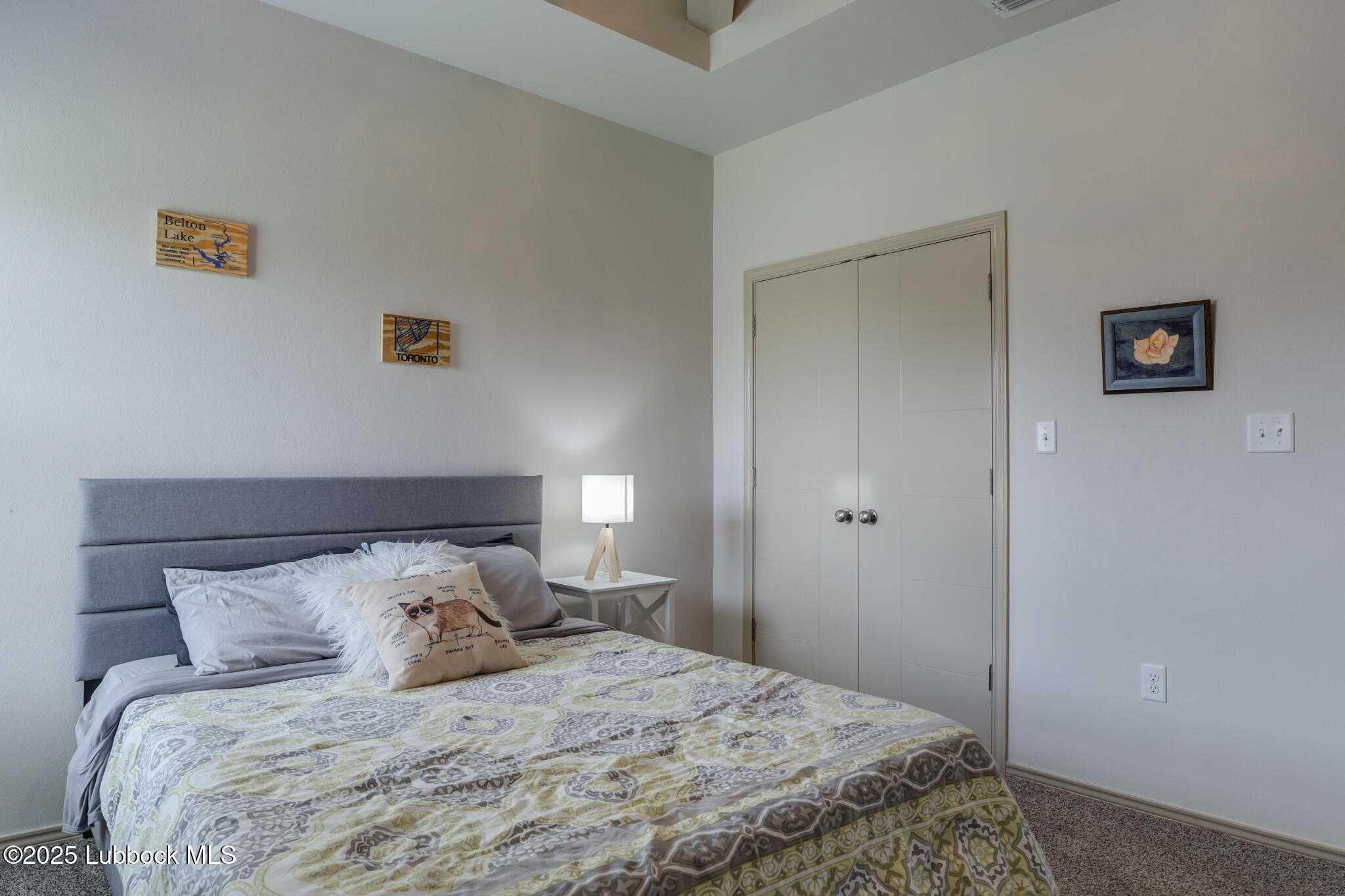 5218 Lehigh Street Lubbock, TX 79416 - Photo 25 of 39 a bedroom with a bed and a night stand