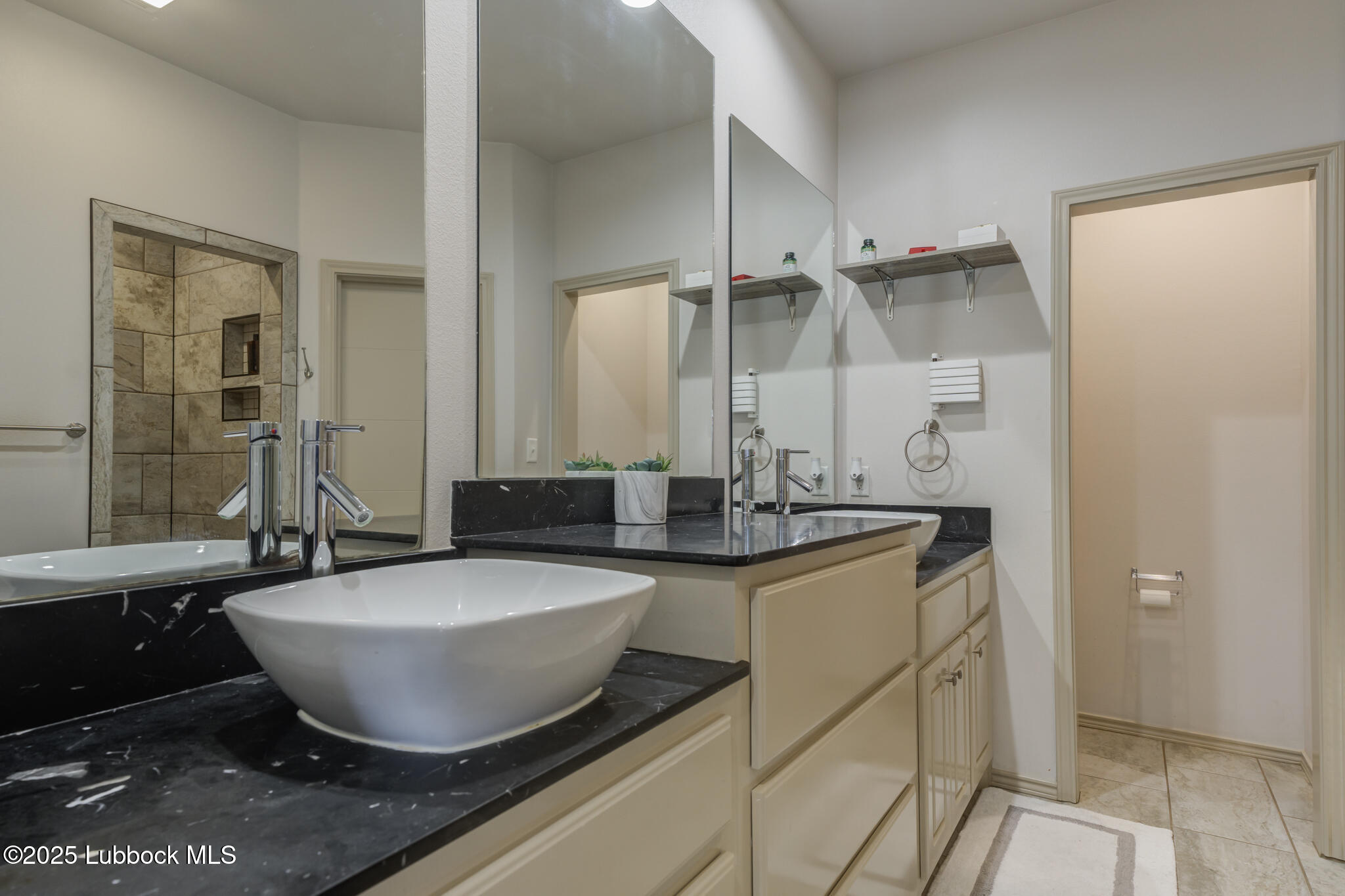 5218 Lehigh Street Lubbock, TX 79416 - Photo 26 of 39 a view of a bathroom with sink and mirror