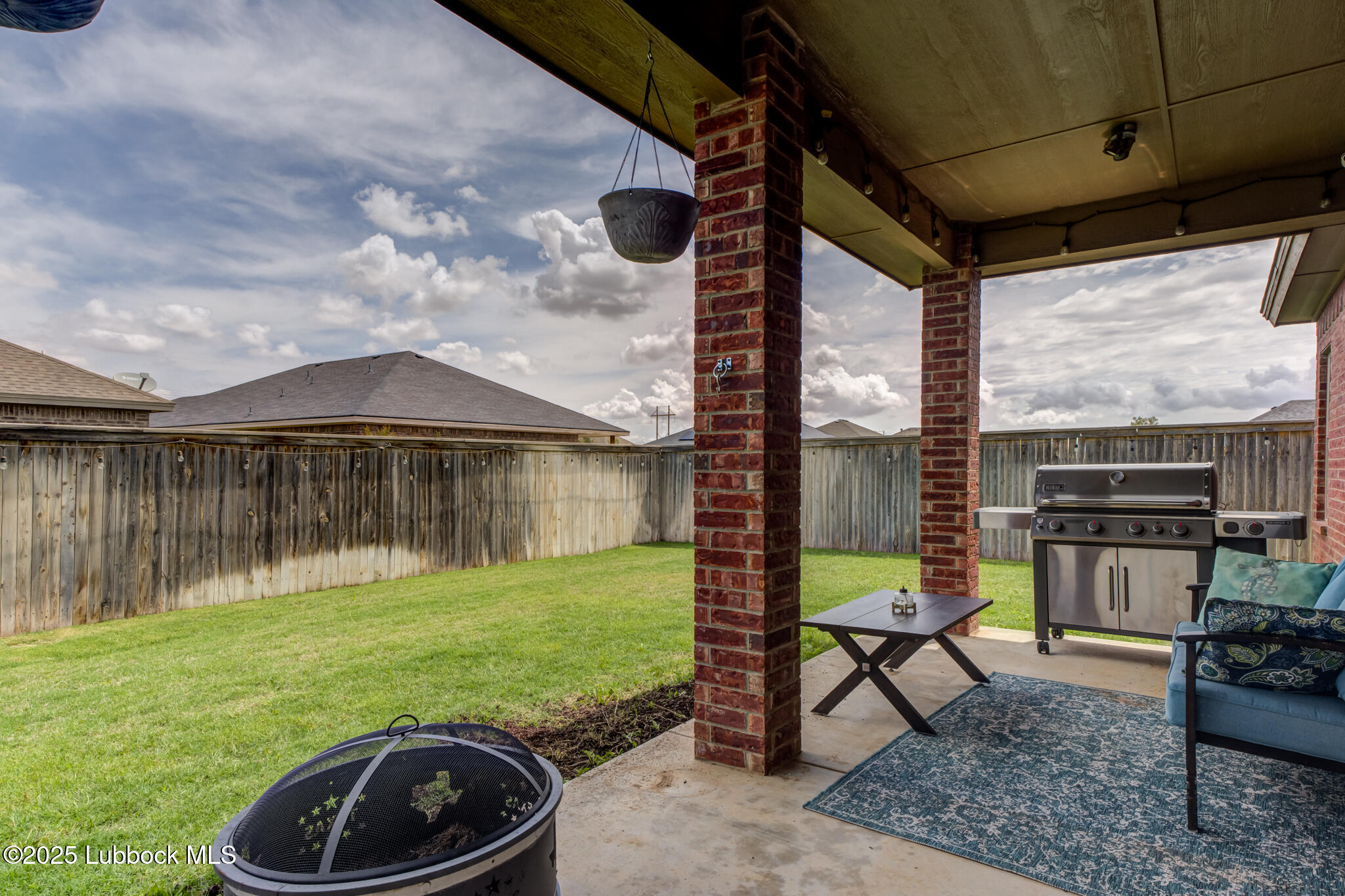5218 Lehigh Street Lubbock, TX 79416 - Photo 37 of 39 a view of a chair and table in backyard of the house