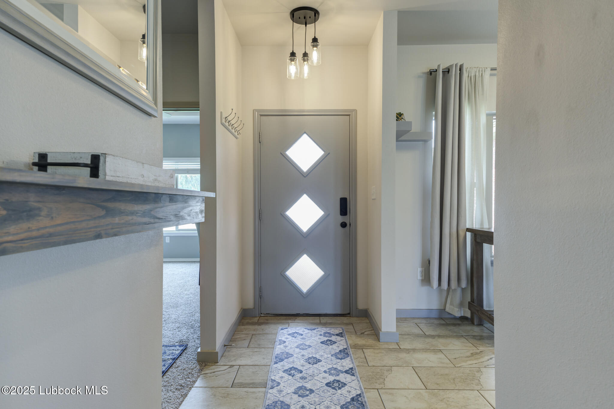 5218 Lehigh Street Lubbock, TX 79416 - Photo 5 of 39 a bathroom with a light fixture and a mirror