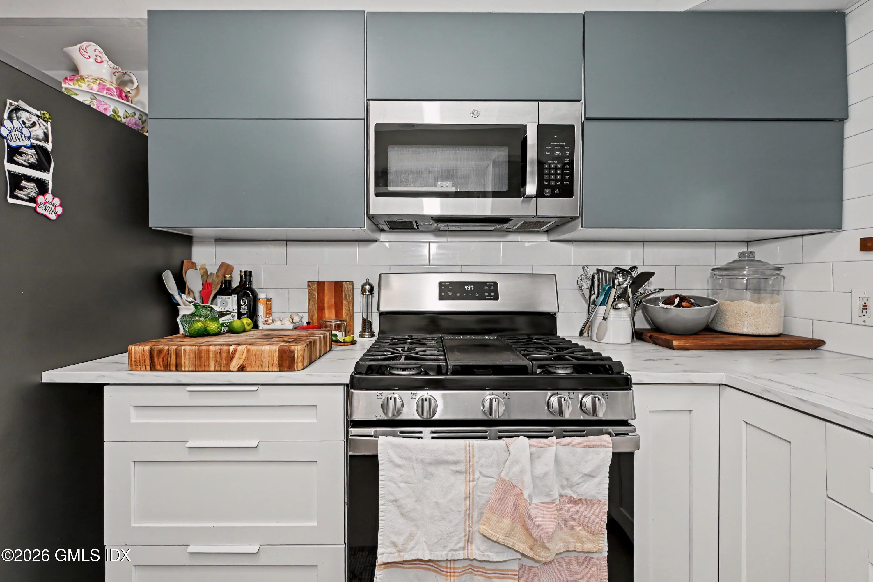 37 Prospect Street Greenwich, CT 06830 - Photo 5 of 41 a kitchen with stainless steel appliances granite countertop a stove and a microwave