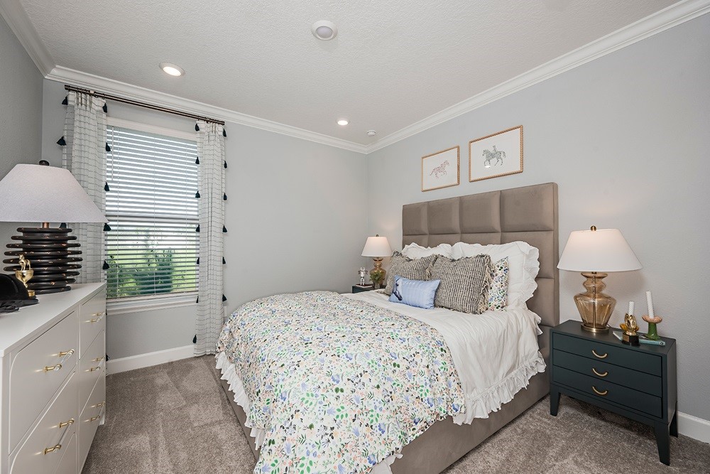 86646 Swift Launch Path Yulee, FL 32097 - Photo 19 of 30 a bedroom with a bed and a lamp on dresser