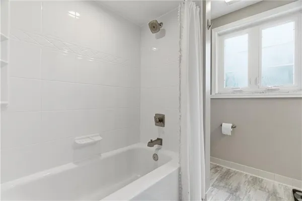 a bathroom with bathtub and shower