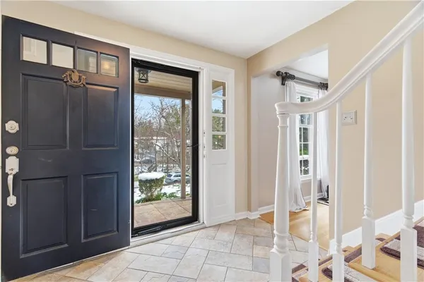 a view of entryway with window and front door