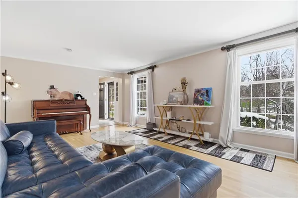 a living room with furniture stove and a window