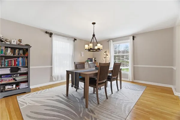 a dining room with a table and chairs