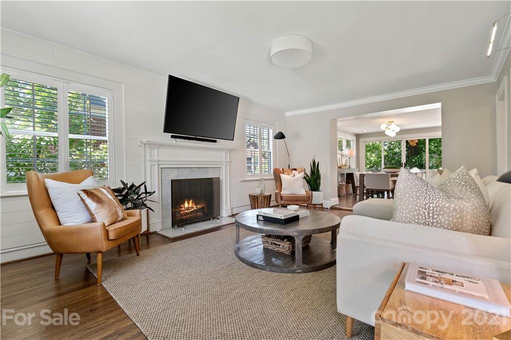 1305 Lilac Road Charlotte, NC 28209 - Photo 14 of 47 a living room with furniture a flat screen tv and a fireplace