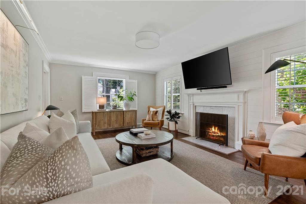 1305 Lilac Road Charlotte, NC 28209 - Photo 15 of 47 a living room with furniture a flat screen tv and a fireplace