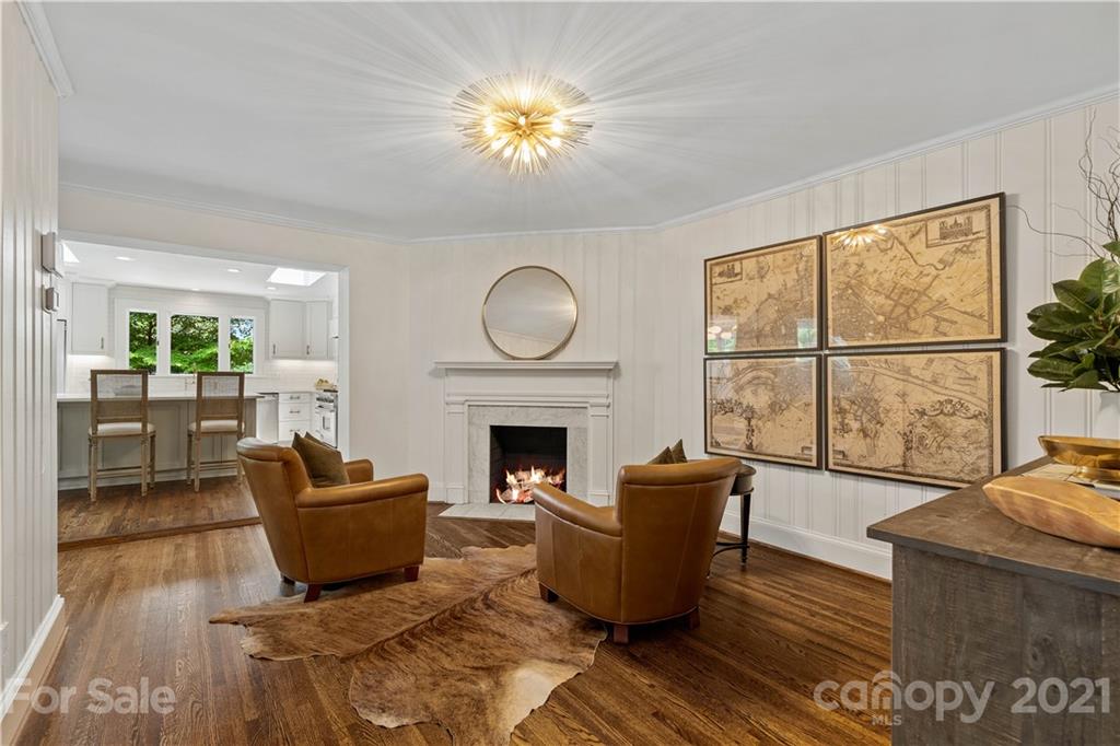 1305 Lilac Road Charlotte, NC 28209 - Photo 16 of 47 a living room with furniture a fireplace and a floor to ceiling window