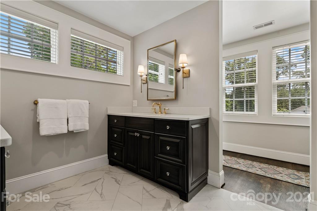 1305 Lilac Road Charlotte, NC 28209 - Photo 18 of 47 a bathroom with a sink and a mirror