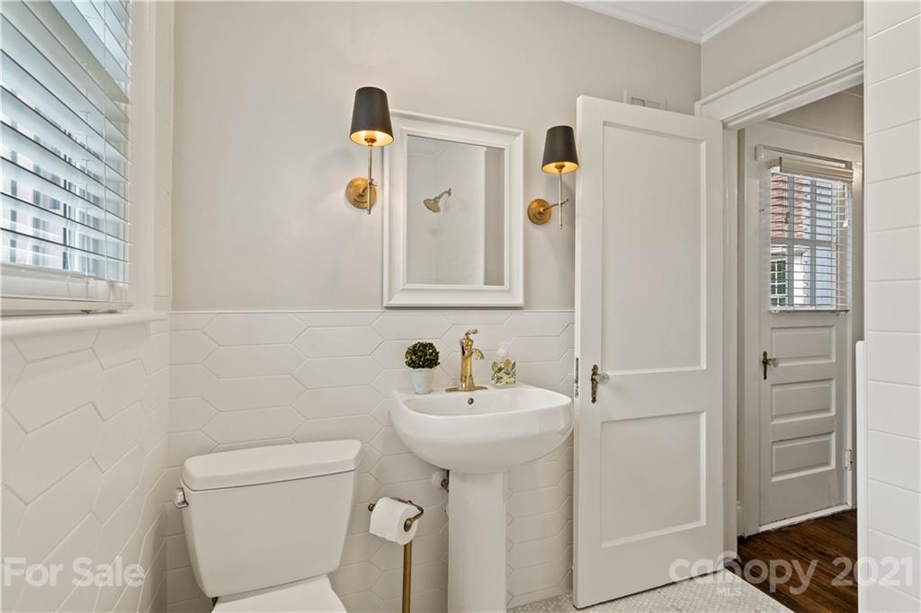 1305 Lilac Road Charlotte, NC 28209 - Photo 21 of 47 a bathroom with a sink toilet and mirror