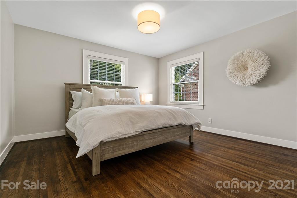 1305 Lilac Road Charlotte, NC 28209 - Photo 22 of 47 a bed sitting in a bedroom next to a window