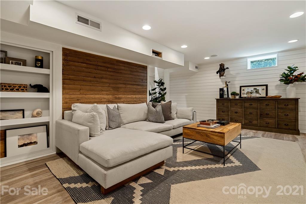 1305 Lilac Road Charlotte, NC 28209 - Photo 26 of 47 a living room with furniture a rug and a window
