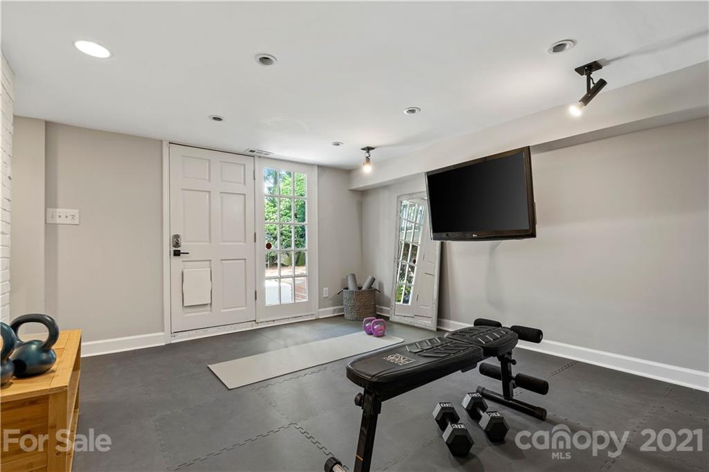 1305 Lilac Road Charlotte, NC 28209 - Photo 31 of 47 a living room with furniture and a flat screen tv