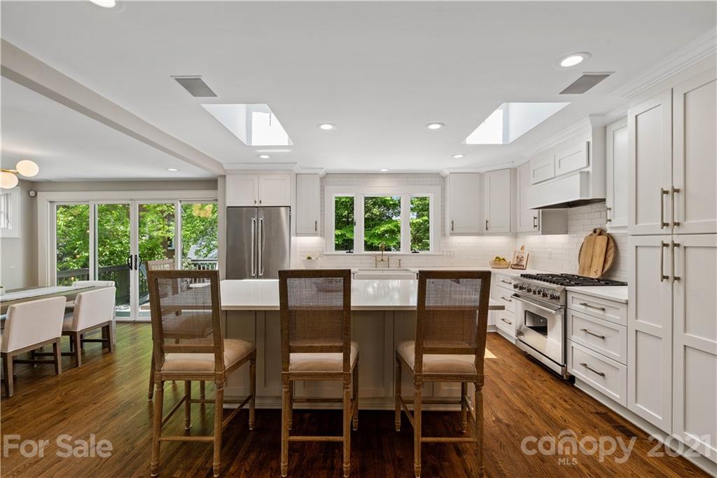 1305 Lilac Road Charlotte, NC 28209 - Photo 34 of 47 a view of a dining room with furniture and wooden floor
