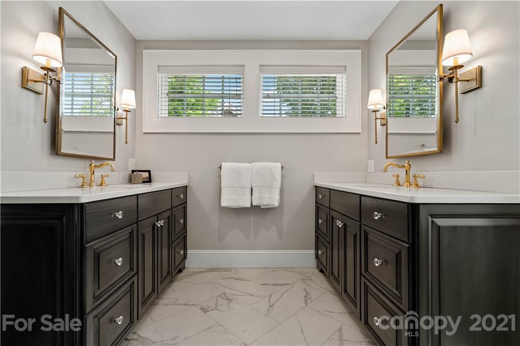 1305 Lilac Road Charlotte, NC 28209 - Photo 6 of 47 a spacious bathroom with a double vanity sink a mirror and a bathtub