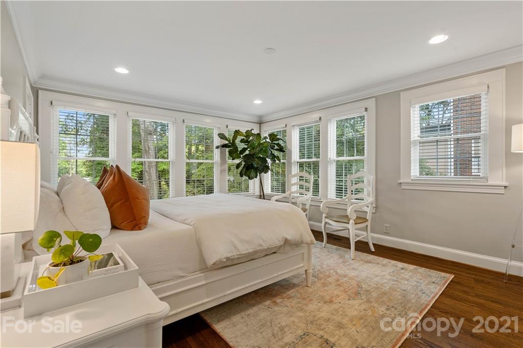 1305 Lilac Road Charlotte, NC 28209 - Photo 9 of 47 a bed sitting in a bedroom next to a window