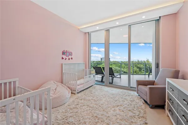 a bedroom with furniture and a large window