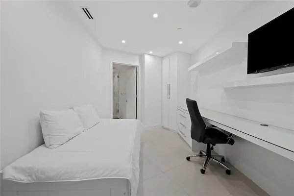 a view of a livingroom with workspace and a couch