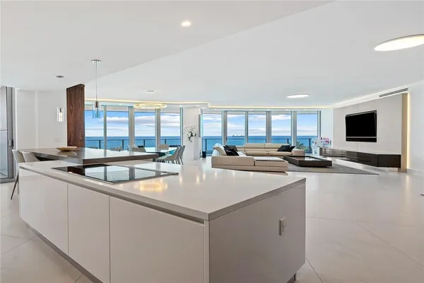 a kitchen with stainless steel appliances granite countertop a sink and a stove