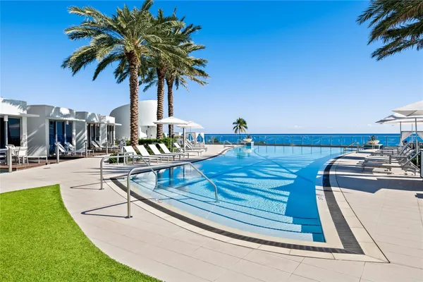 a view of swimming pool with a table and chairs