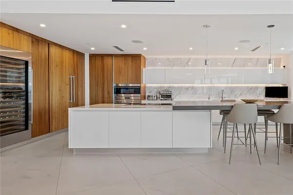 a kitchen with kitchen island cabinets and chairs