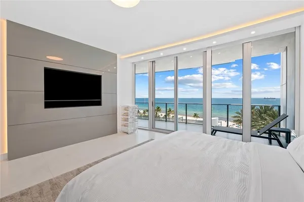 a bedroom with a large bed and a large window