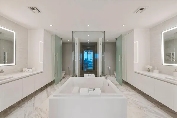 a bathroom with a bathtub a sink and a window