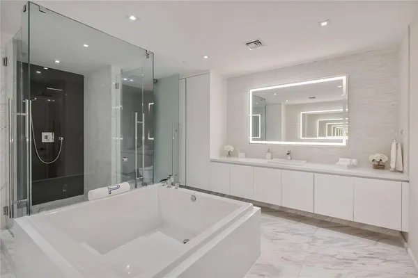 a bathroom with a bathtub and a sink