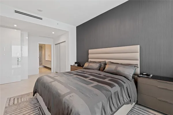 a bedroom with a bed and a night stand