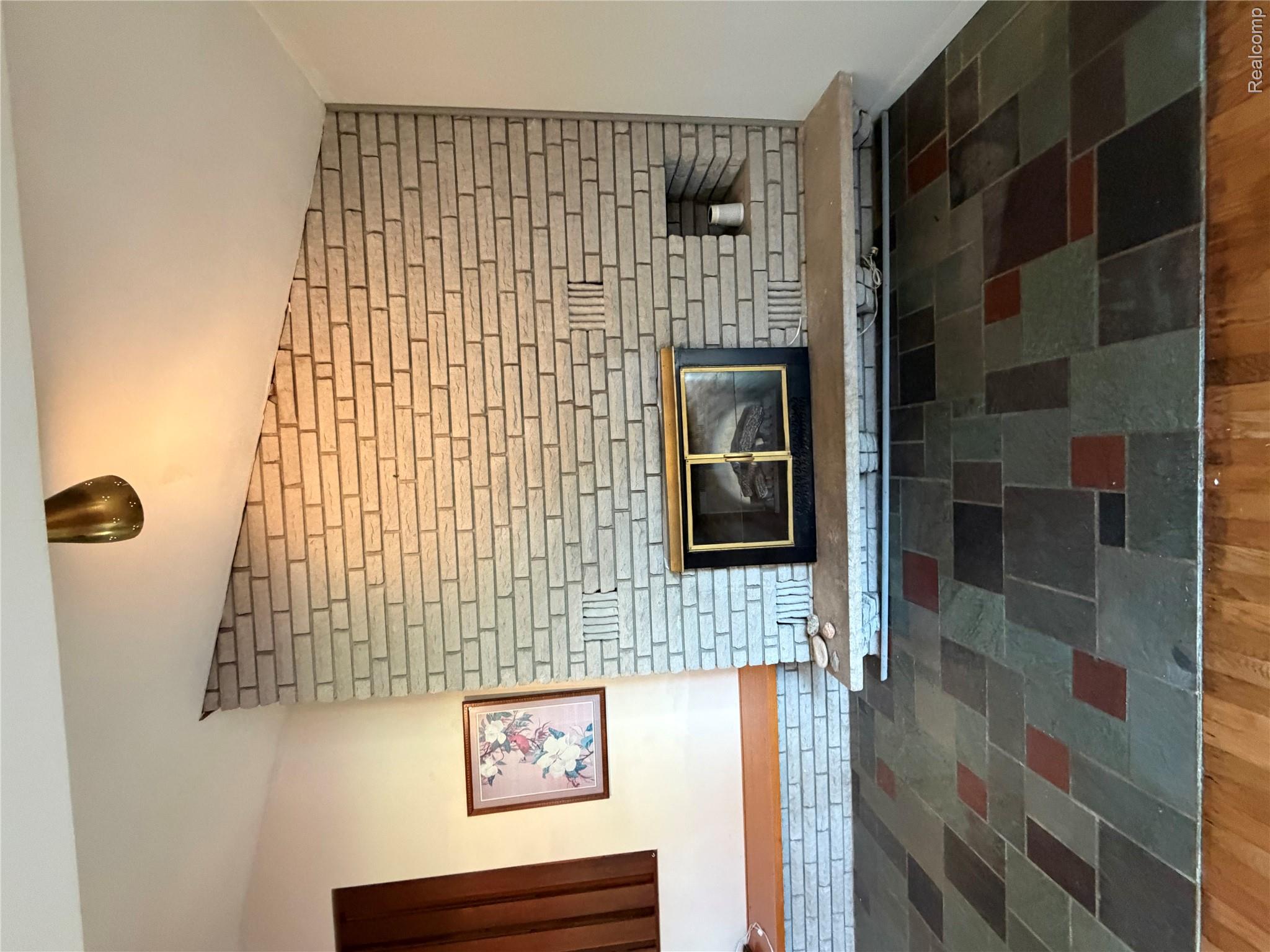 8886 East Burnside Road Brown City, MI 48416 - Photo 18 of 22 Textured brick fireplace with an integrated firebox and hearth