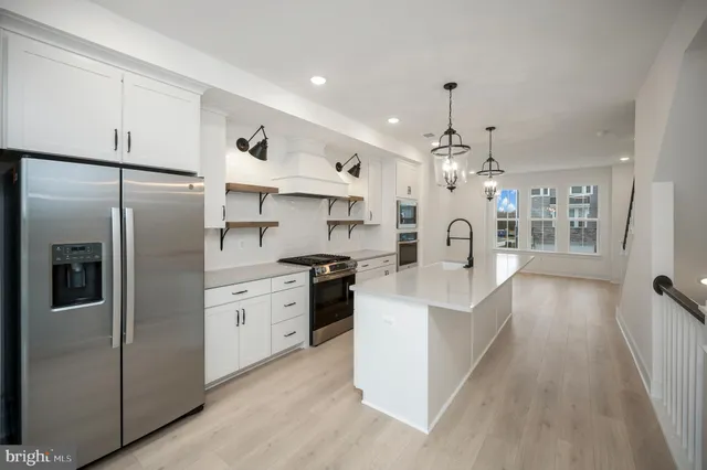 a kitchen with stainless steel appliances a refrigerator and cabinets