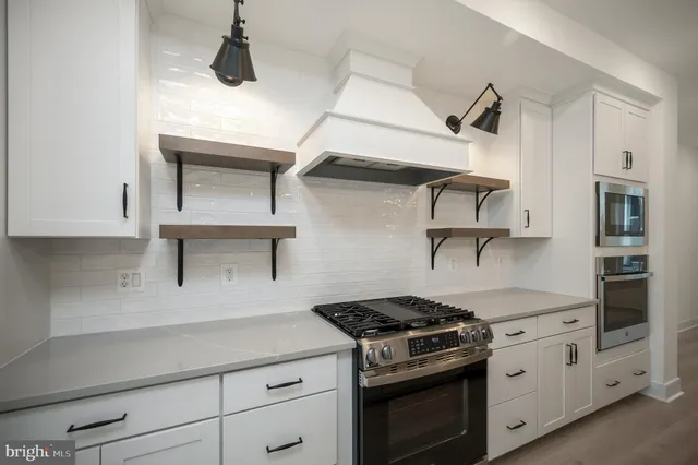 a kitchen with sink stove and cabinets