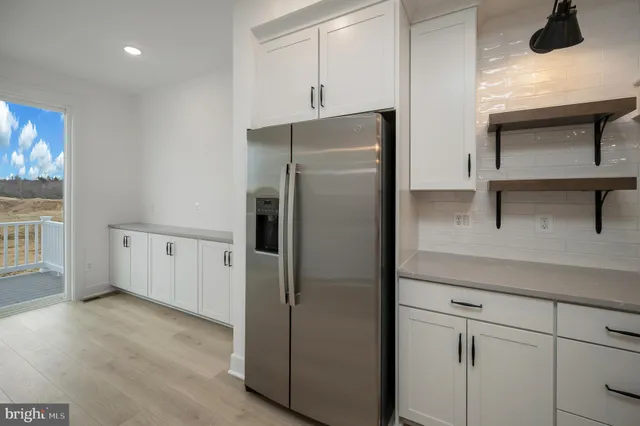 a stove top oven sitting inside of a kitchen