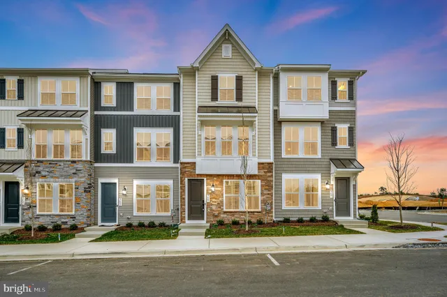 a front view of a residential apartment building with a yard