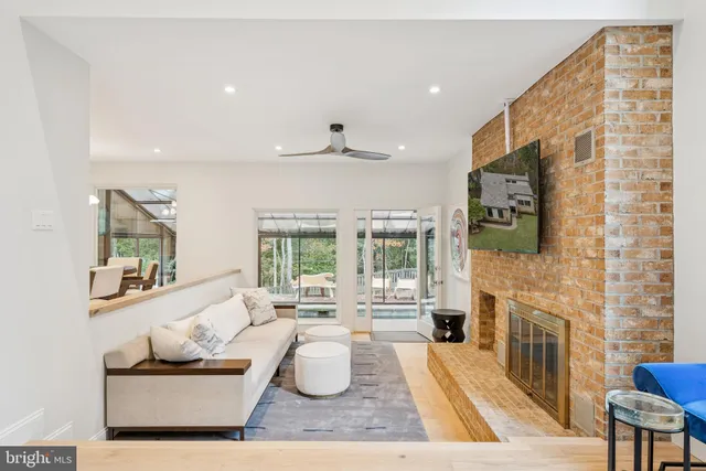 a spacious bedroom with a bed a table and a dresser