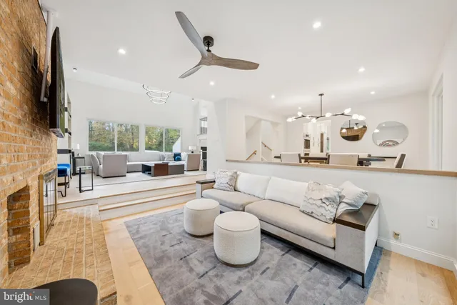 a bedroom with a bed couch and large window