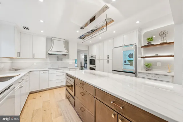 a spacious bathroom with a double vanity sink a large mirror and a bathtub