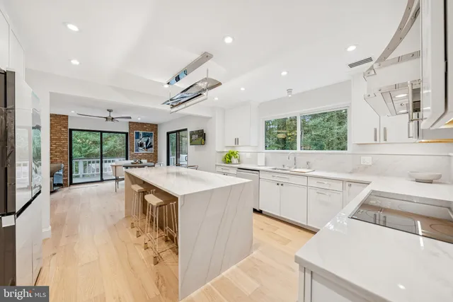 a bathroom with a sink and mirror with bathtub