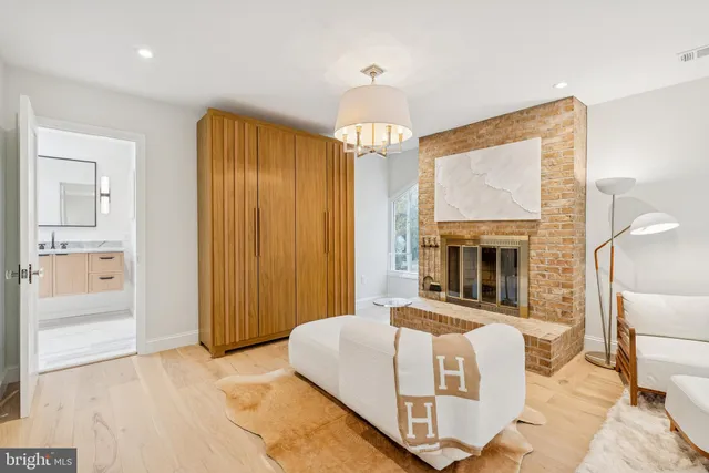 a view of house with a large window and potted plants
