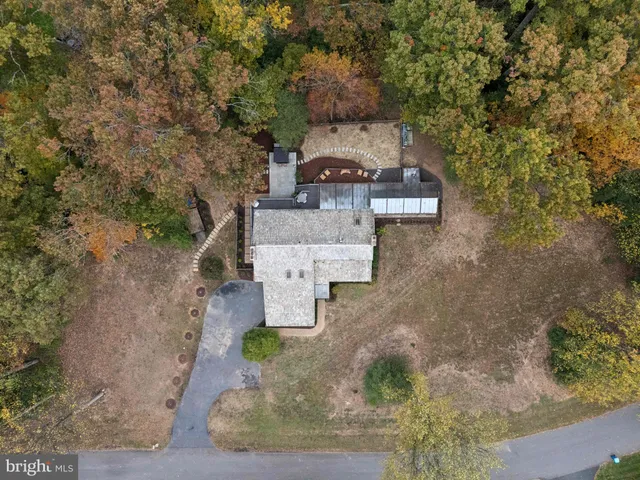 a living room with furniture a flat screen tv and a large window