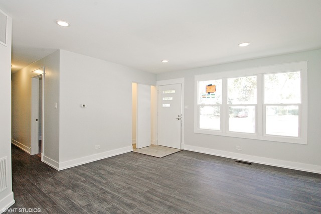 425 Bode Road Hoffman Estates, IL 60169 - Photo 2 of 11 an empty room with wooden floor and window