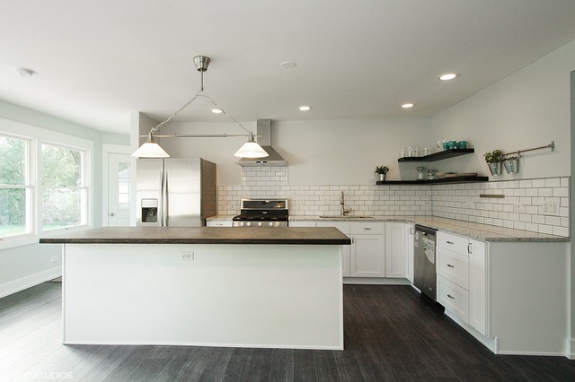 425 Bode Road Hoffman Estates, IL 60169 - Photo 4 of 11 a kitchen with stainless steel appliances granite countertop a sink a stove and a wooden floors