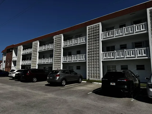 a couple of cars parked in front of a building