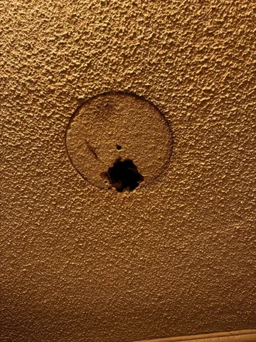 a living room with a flat screen tv and a floor to ceiling window