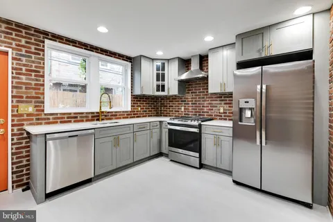 a kitchen with stainless steel appliances a refrigerator sink and cabinets