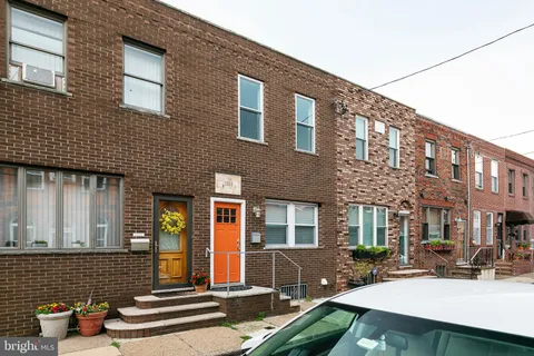 a front view of a house with outdoor seating