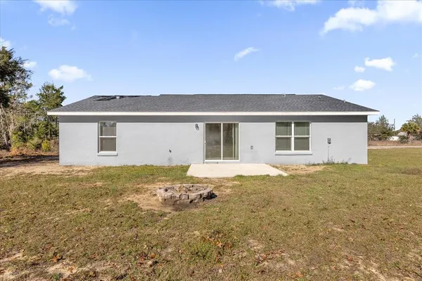 a view of a house with a backyard