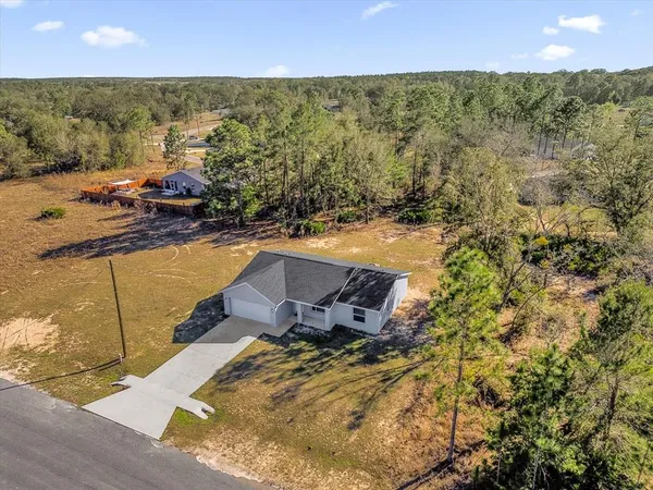 a view of a house with a yard and garage