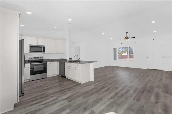 a kitchen with a refrigerator and a stove top oven